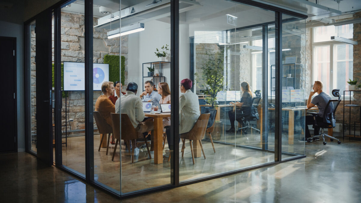 Diverse Group of Professional Businesspeople Meeting in the Modern Office Conference Room. Creative Team Discuss App Design, Analyze Data, Plan Marketing Strategy, Disrupt Social Media, Growth Hack